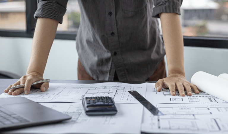 Designer reviewing plans for a custom home remodel in San Diego, CA