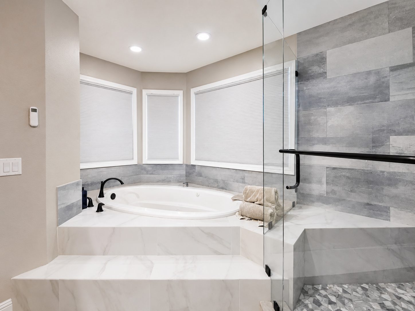 Modern bathroom renovation in San Diego with custom tile shower, soaking tub, frameless glass enclosure, and contemporary finishes by Y9 Construction.